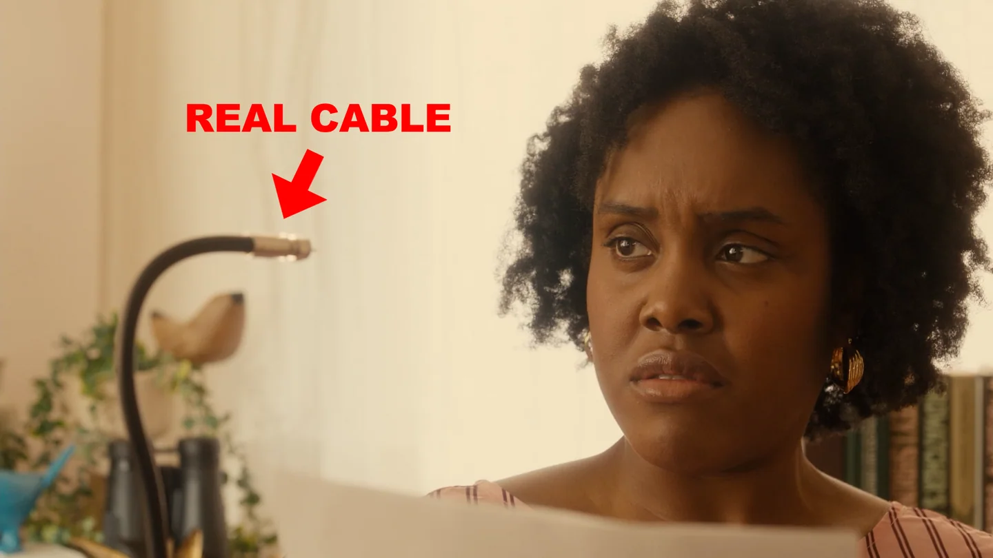 Behind-the-scenes frame labels the practical cable puppet beside the performer.