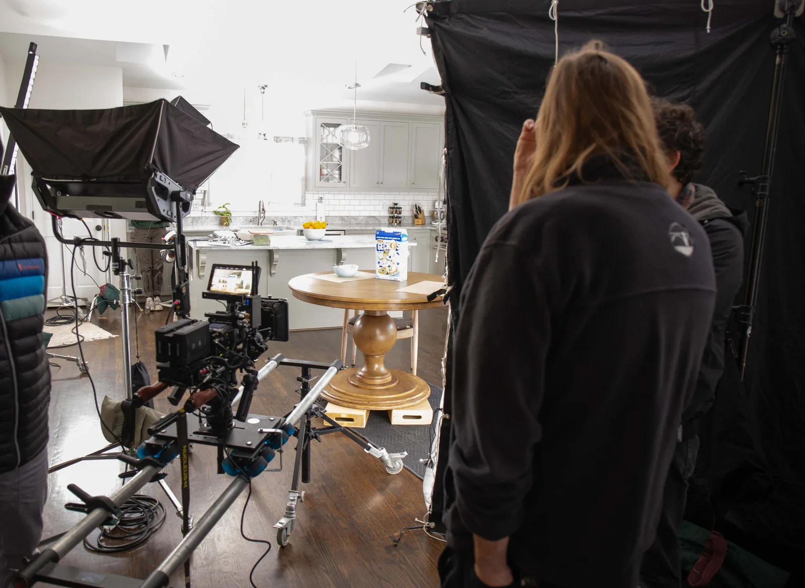 Camera and lighting setup on the practical kitchen set.
