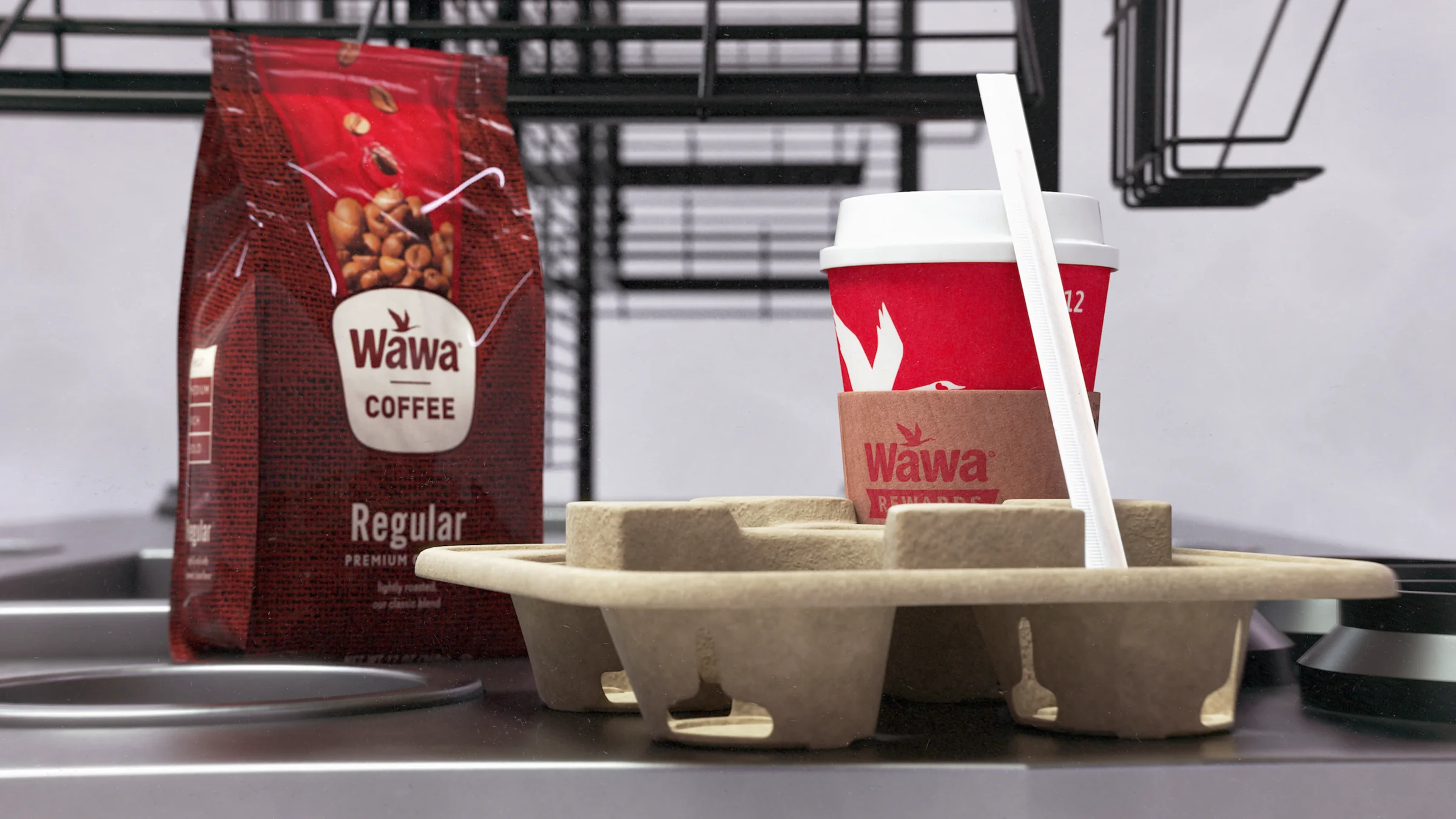 Close rendering of a Wawa coffee bag, cup, sleeve, straw, and molded drink carrier inside the finished display.