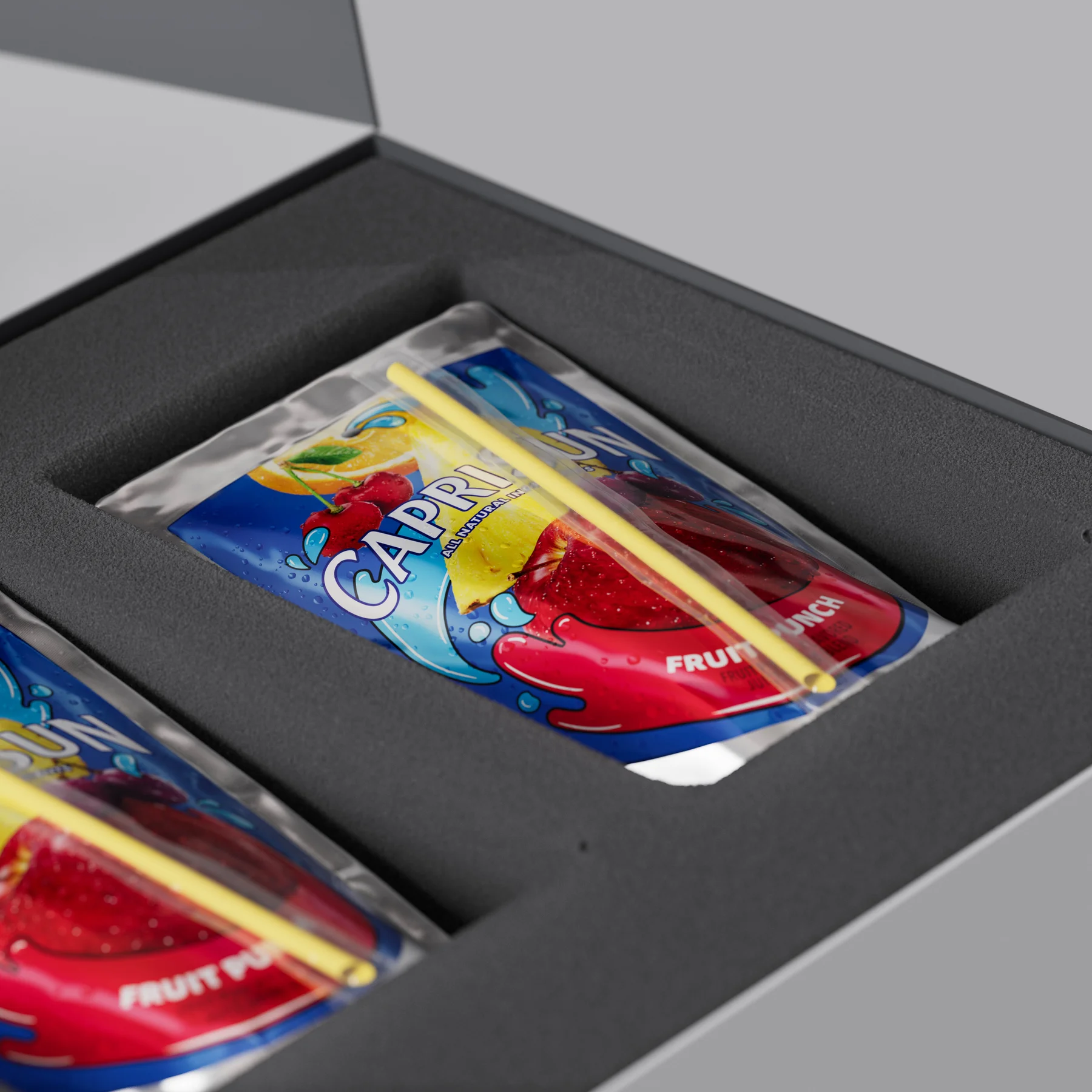 Close view of the Capri Sun pouches and fitted foam inside the Noise Tech presentation box.